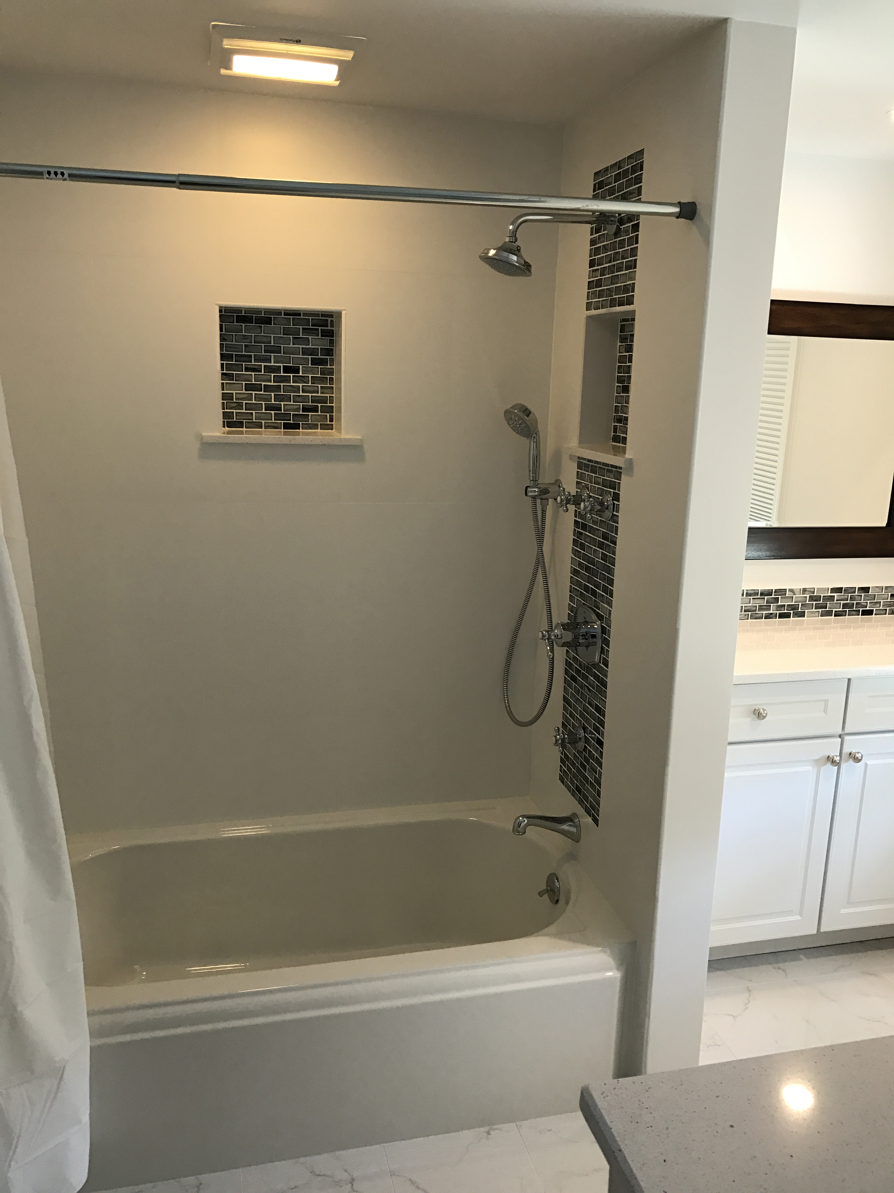 Shower/tub combo, mosaic tile and built in niches