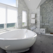 Master bath with marble tile and frameless glass shower